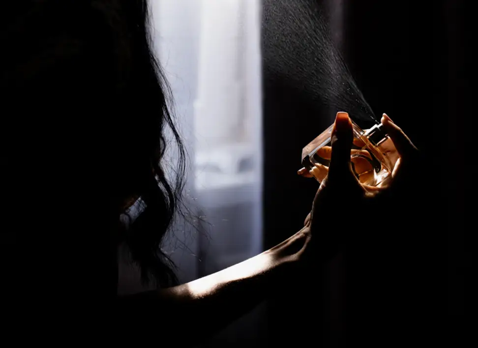 Close-up of perfume being sprayed, symbolizing our expertise in custom fragrance development.